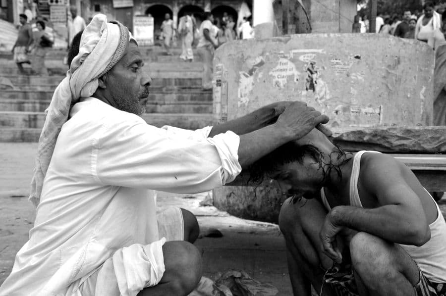 Barber shaving a client's head clean