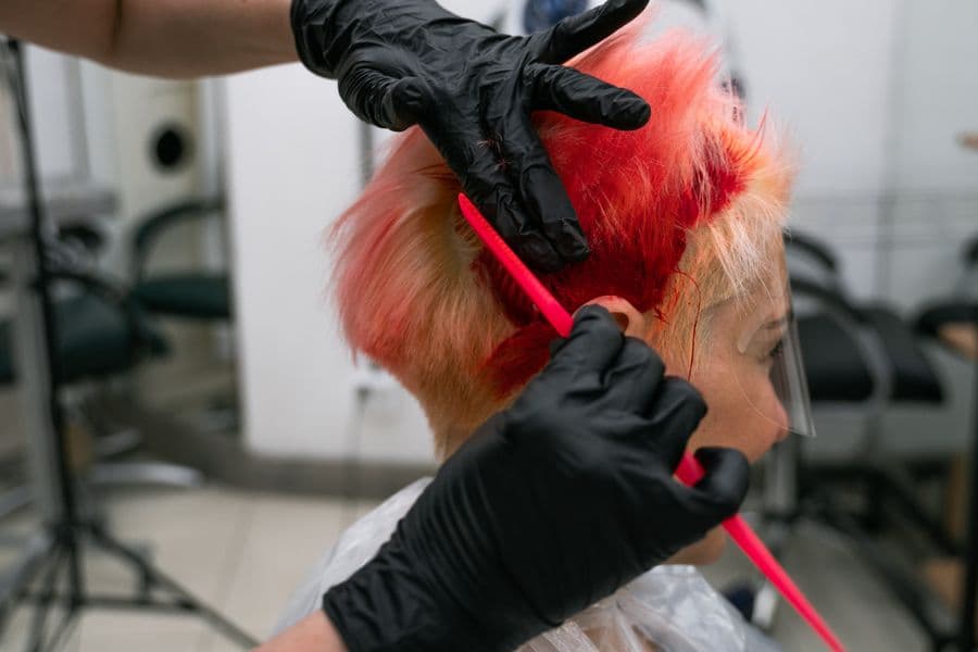 Stylist applying hair colour
